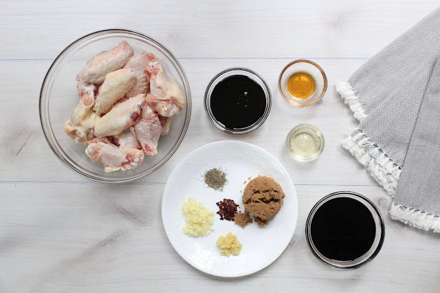 Bowls of chicken wings and marinade ingredients