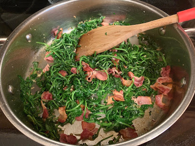 Watercress and bacon cooking in a skillet