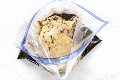 Raw chicken legs in a bag with marinade