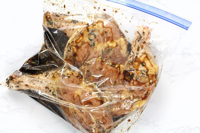 Raw chicken legs in a bag with marinade
