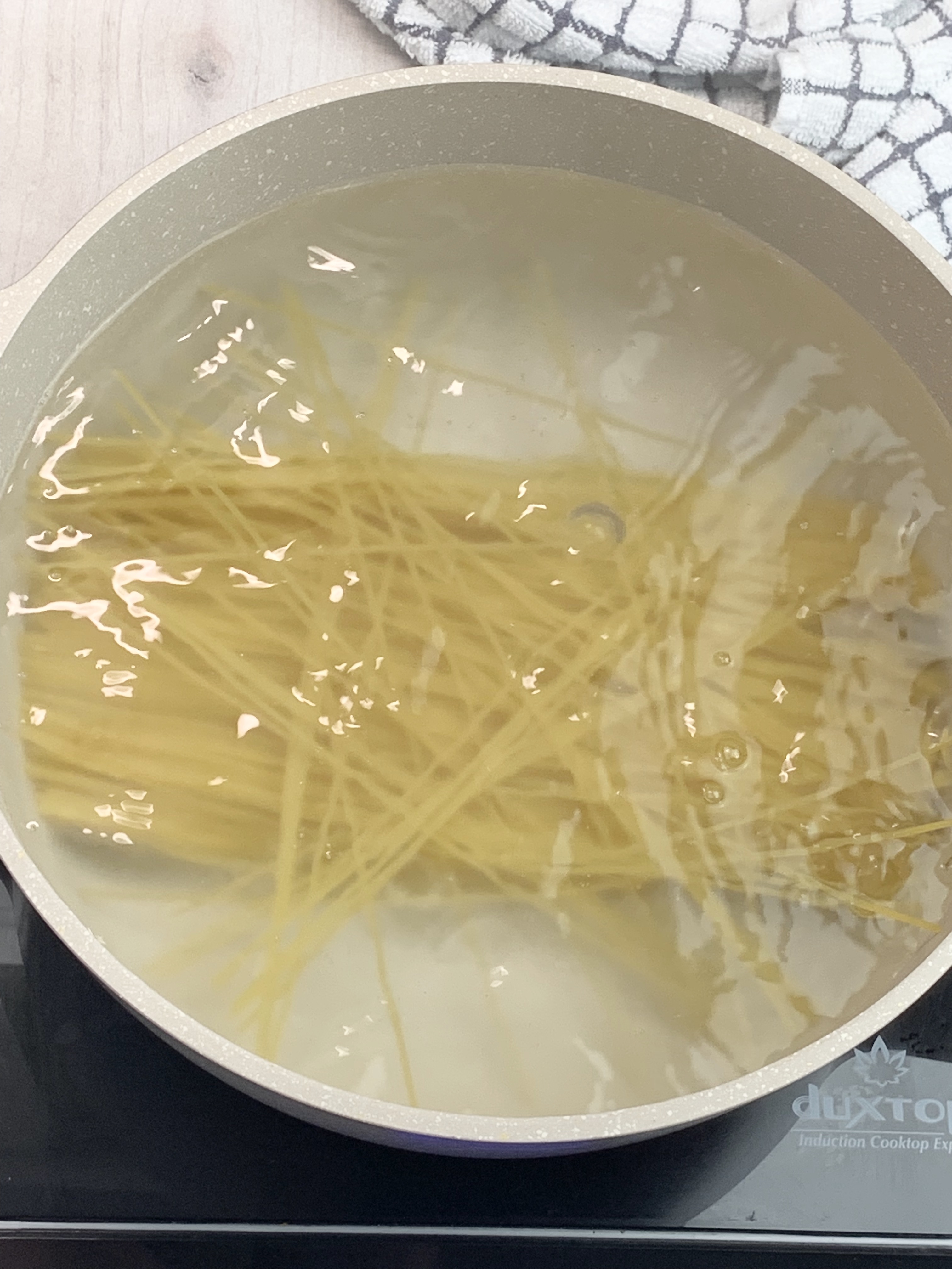Spaghetti boiling in pot
