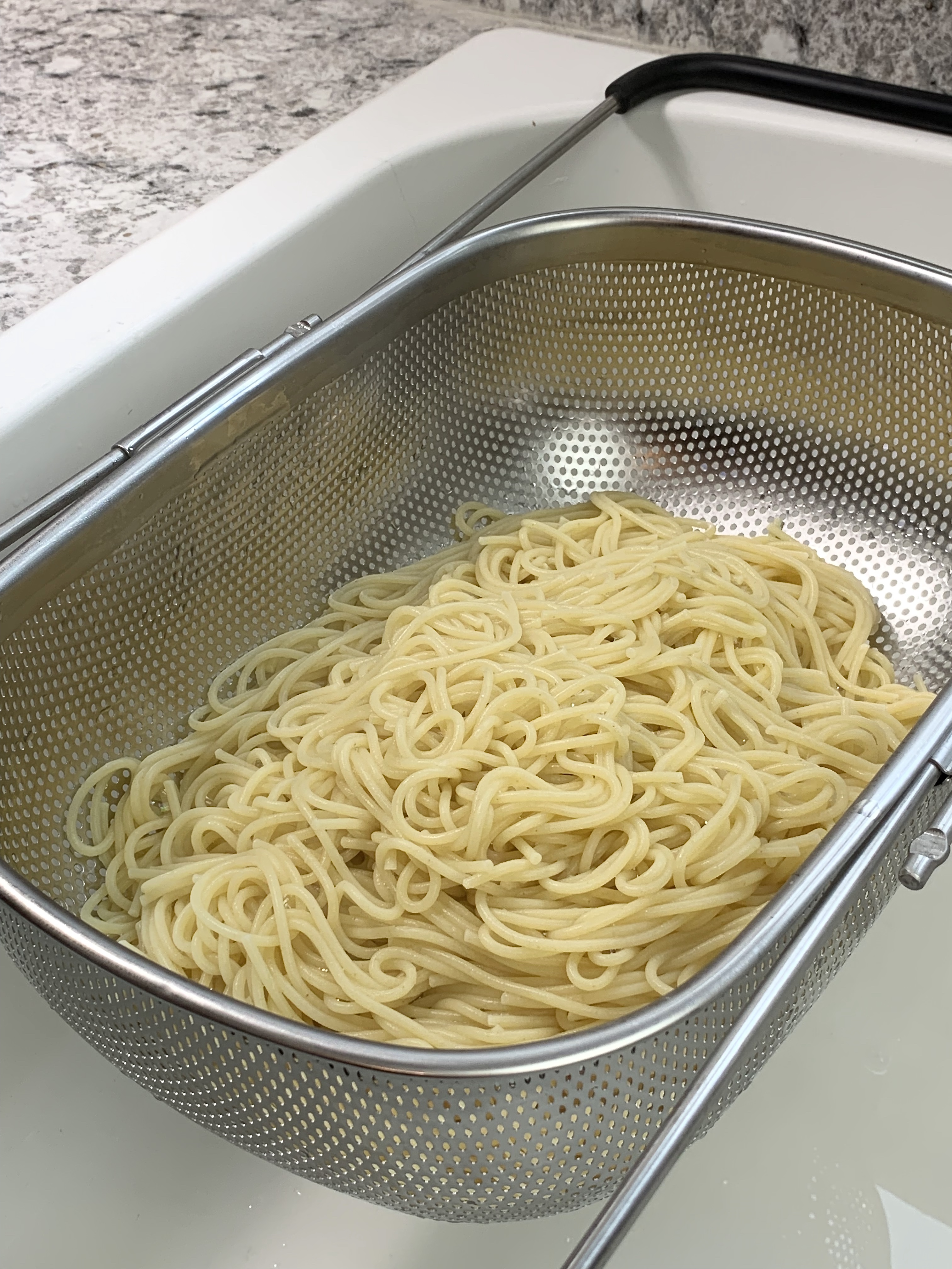 Spaghetti draining in colander 