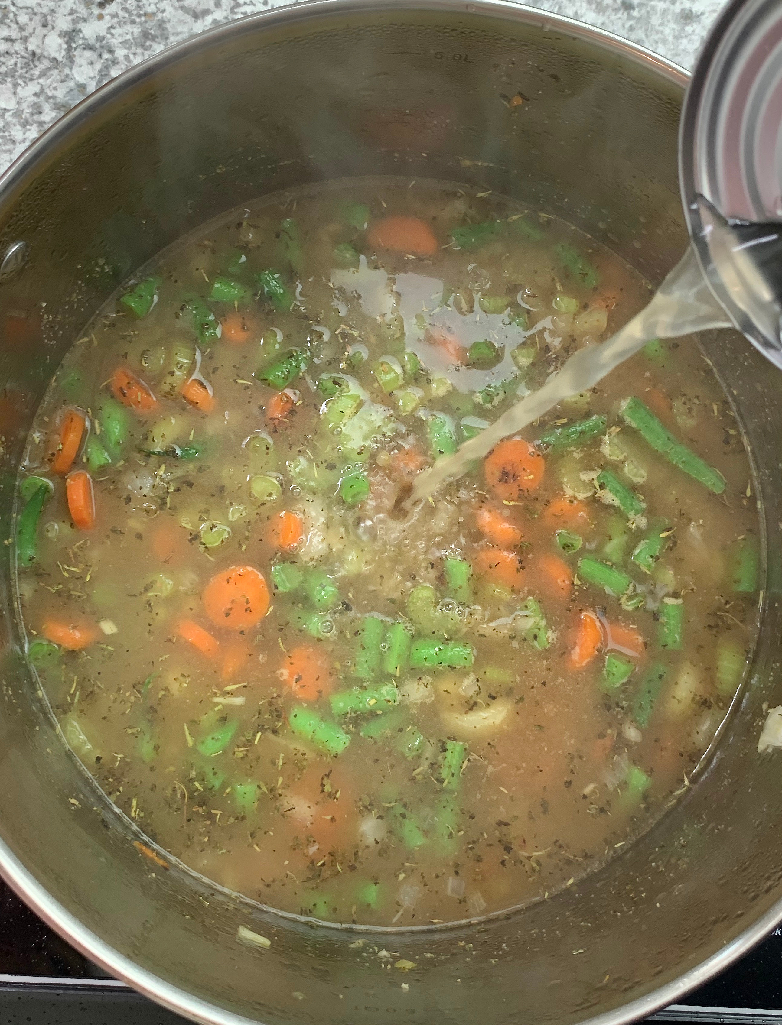 chicken broth poured into pan