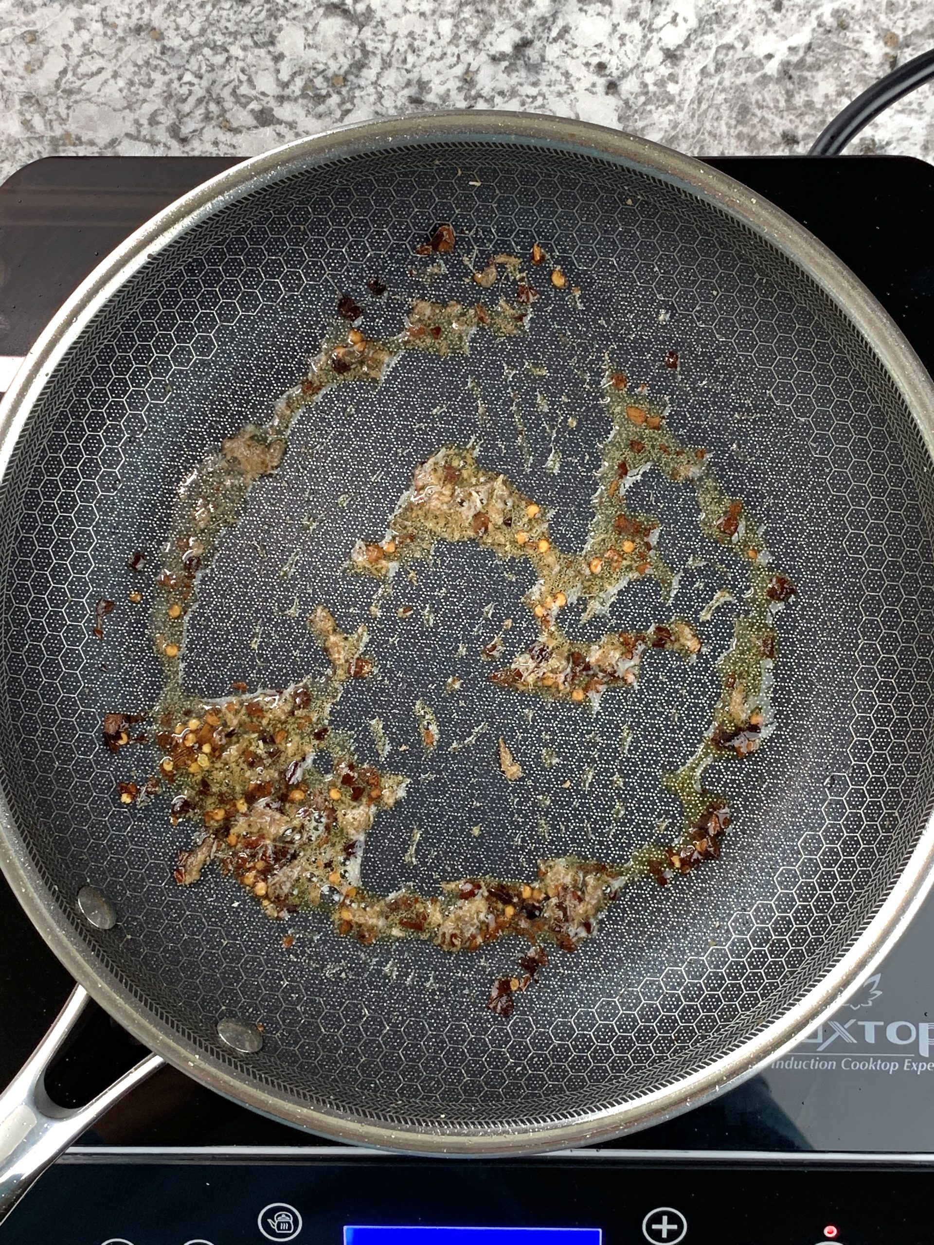 red pepper and anchovies in skillet