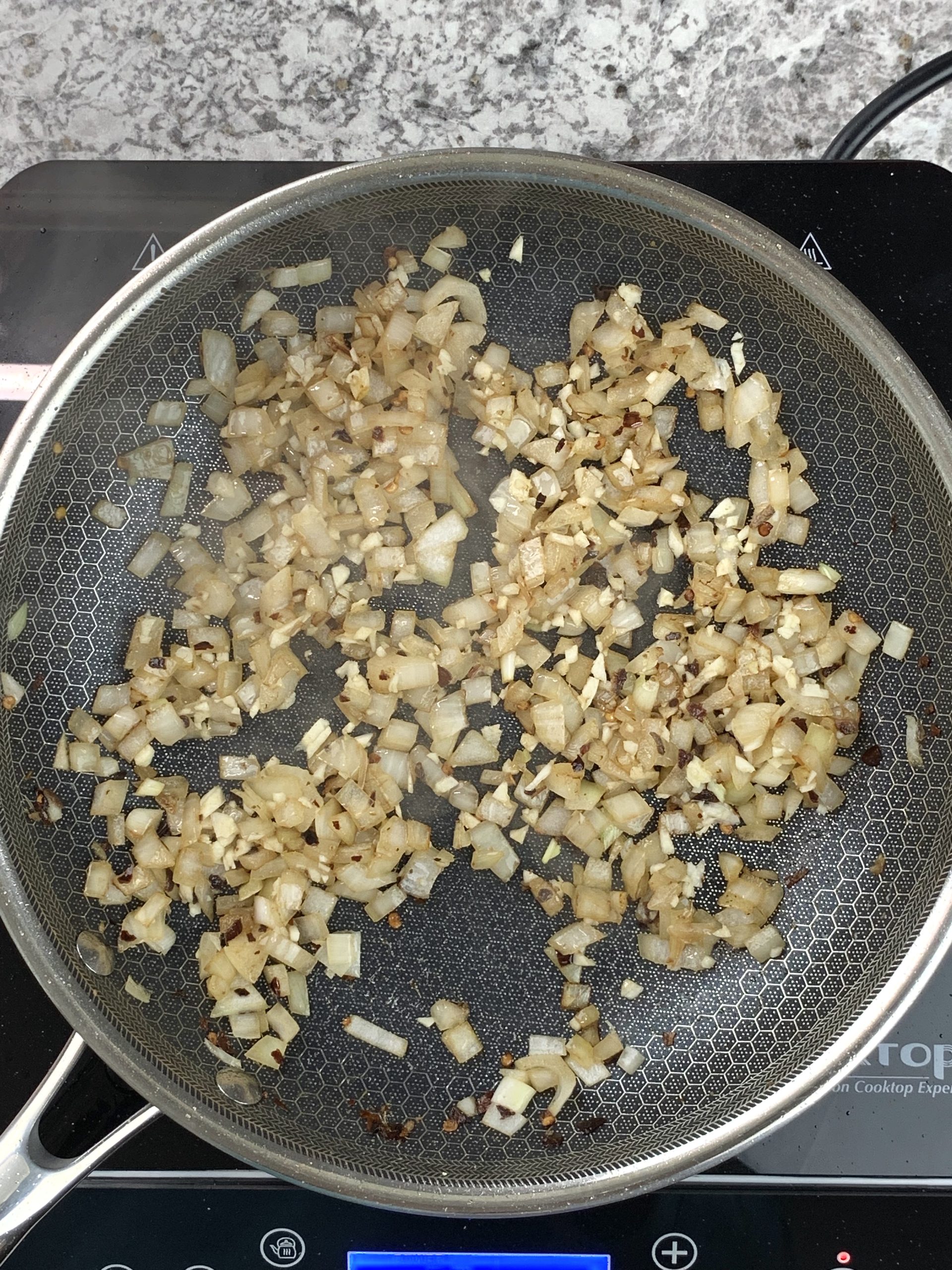 onion and garlic cooking in skillet