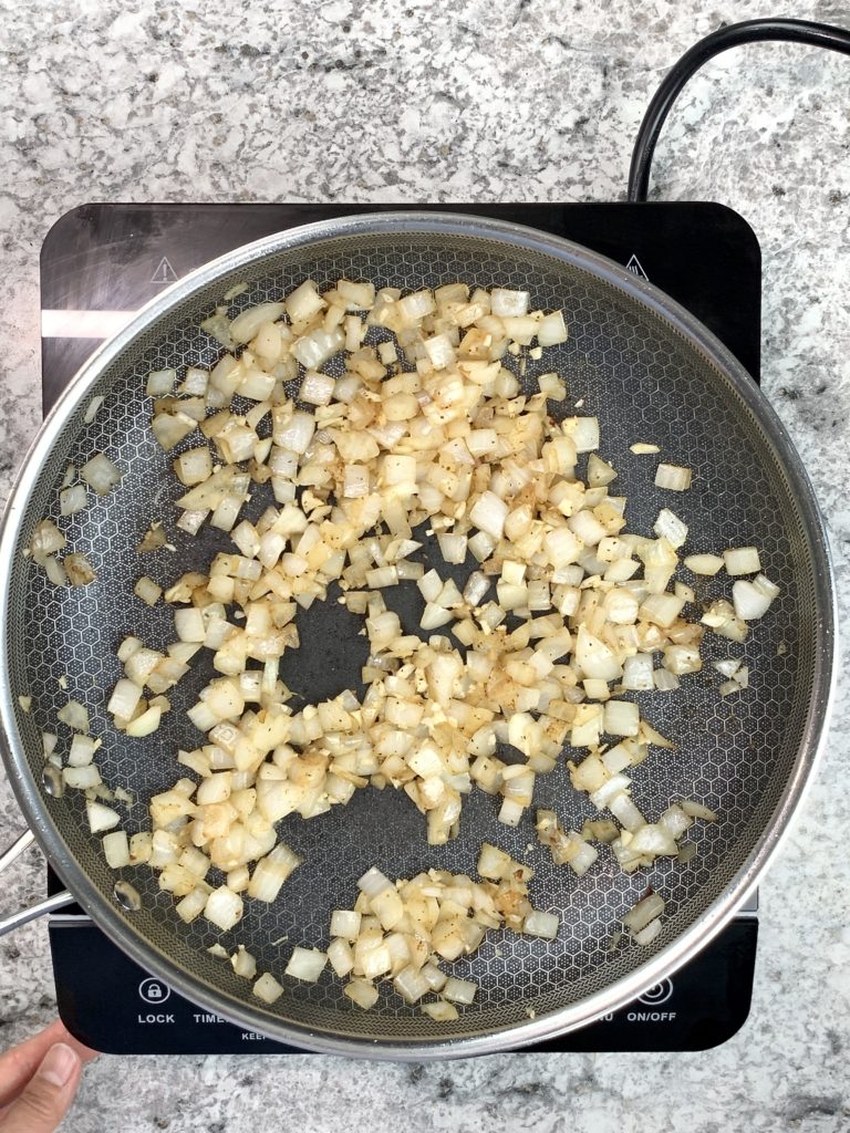 onion and garlic cooking in skillet