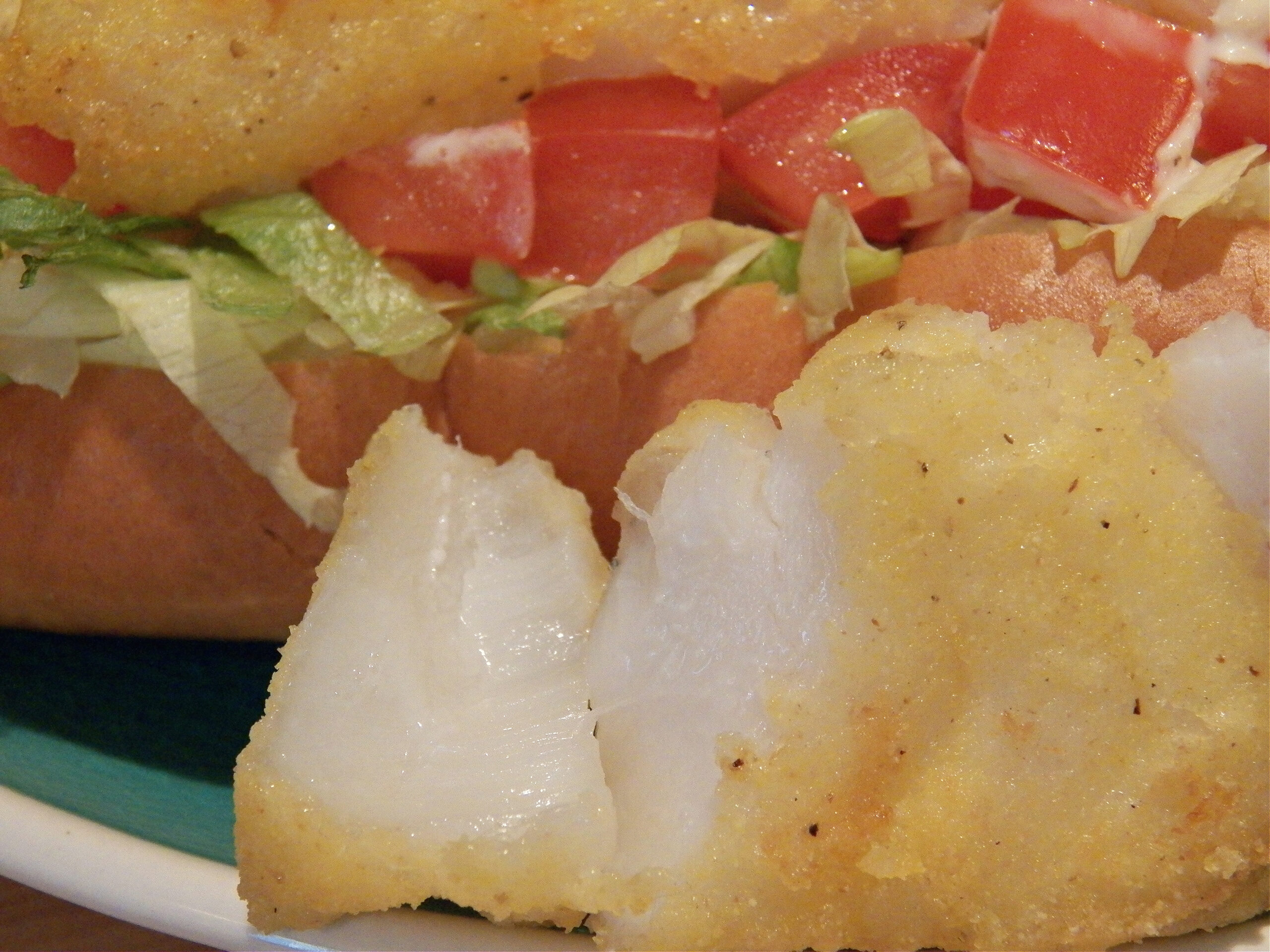 closeup view of cooked, bread fish on plate